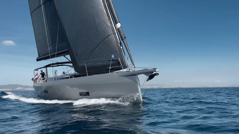  Yacht Photos Pics Sleek 2026 Ice Yachts 62 Targa sailing on open sea under clear blue sky.