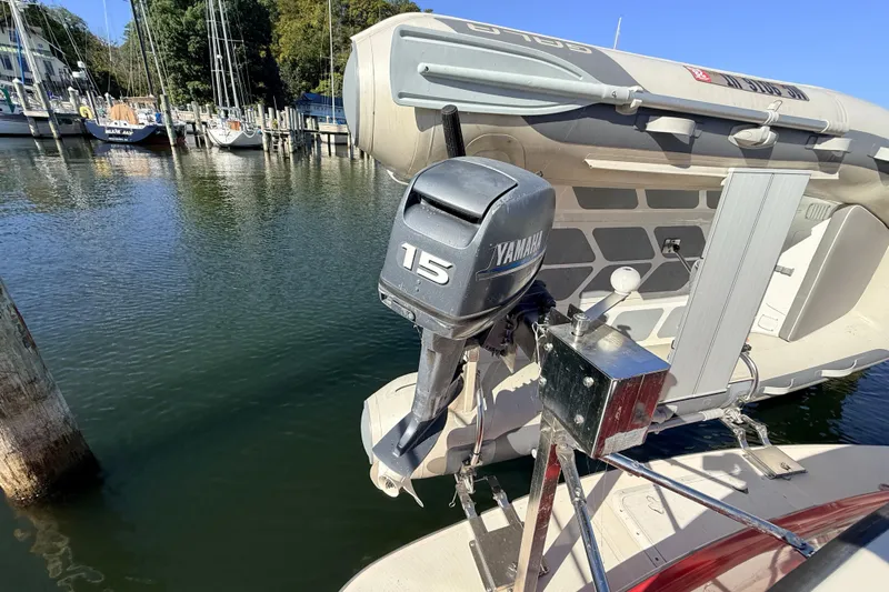 Nomad Yacht Photos Pics Yamaha 15 outboard motor on a 2000 Nordic Tug 37, docked at a marina.