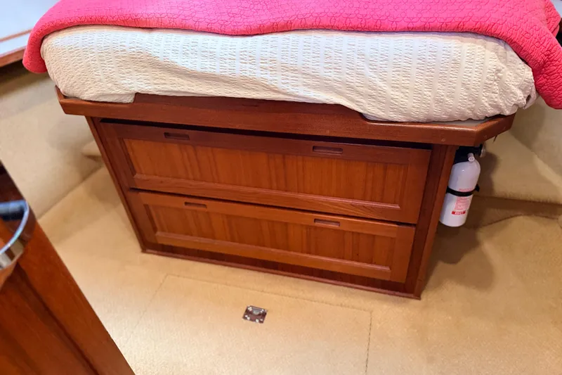 Nomad Yacht Photos Pics Wooden storage drawers under bed in 2000 Nordic Tug 37 boat cabin.