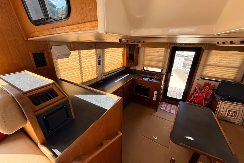 Nomad Yacht Photos Pics Interior of a 2000 Nordic Tug 37, featuring a cozy kitchen and dining area.