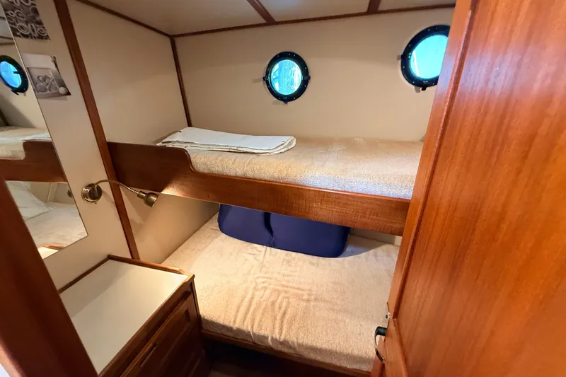 Nomad Yacht Photos Pics Cozy cabin with bunk beds in a 2000 Nordic Tug 37 boat.