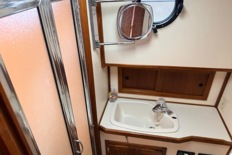 Nomad Yacht Photos Pics Bathroom interior of a 2000 Nordic Tug 37, featuring a sink and mirror.