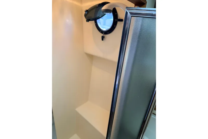 Nomad Yacht Photos Pics Interior of 2000 Nordic Tug 37, featuring a porthole and shower area.