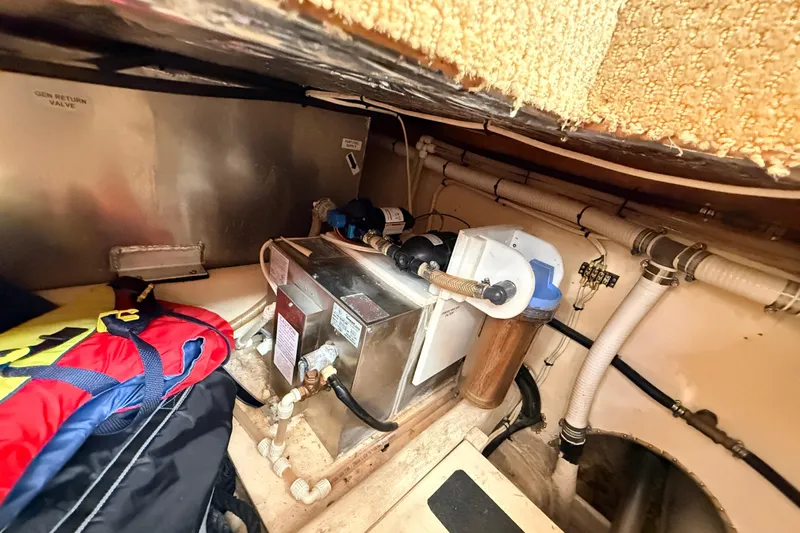 Nomad Yacht Photos Pics Engine room of a 2000 Nordic Tug 37, featuring mechanical components and piping.