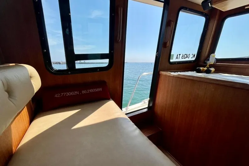 Nomad Yacht Photos Pics Interior of 2000 Nordic Tug 37 with ocean view through windows.