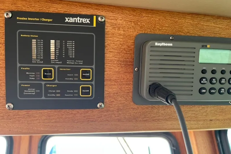 Nomad Yacht Photos Pics Control panel of a 2000 Nordic Tug 37 with Xantrex inverter and Raytheon radio.