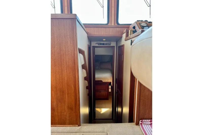 Nomad Yacht Photos Pics Interior view of 2000 Nordic Tug 37, featuring a cozy cabin with wooden finishes.