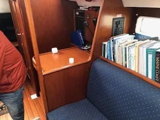 Peregrine Yacht Photos Pics Interior of 2005 Beneteau 423 sailboat with wooden cabinetry and blue upholstered seating.