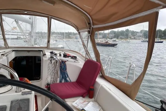 Peregrine Yacht Photos Pics Cockpit view of 2005 Beneteau 423 sailboat with marina in background.