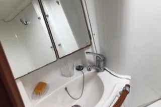 Peregrine Yacht Photos Pics Bathroom sink area in a 2005 Beneteau 423 yacht, featuring a mirror and faucet.