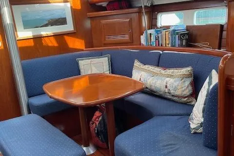 Peregrine Yacht Photos Pics Interior of 2005 Beneteau 423 sailboat with cozy seating and wooden table.