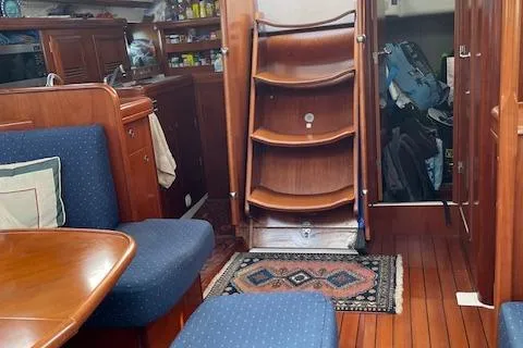 Peregrine Yacht Photos Pics Interior of 2005 Beneteau 423 sailboat with wooden furnishings and blue upholstery.