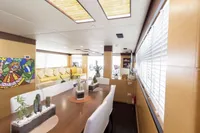 Luxurious interior of 2011 Custom C.boat 27 SC yacht with modern decor and vibrant artwork.