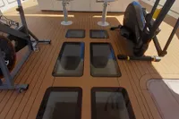 Custom C.boat 27 SC 2011 yacht deck with exercise equipment and glass floor panels.