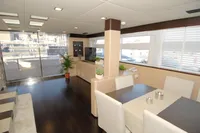 Luxurious interior of 2011 Custom C.boat 27 SC yacht with modern furnishings and large windows.