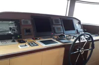 Control panel of 2011 Custom C.boat 27 SC yacht with navigation equipment and steering wheel.