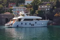 Luxurious 2011 Custom C.boat 27 SC yacht docked near scenic waterfront homes.