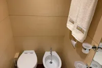 Luxury yacht bathroom with toilet, bidet, and towel on C.boat 27 SC, 2011 model.