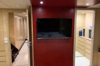 Interior of 2011 Custom C.boat 27 SC yacht with TV and modern wood paneling.