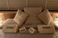 Luxurious bedding with plush pillows and towels on a 2011 Custom C.boat 27 SC.