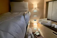 Cozy cabin interior of 2011 Custom C.boat 27 SC with bunk beds and soft lighting.