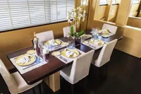 Luxurious dining area on 2011 Custom C.boat 27 SC yacht with elegant table setting.