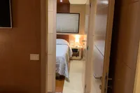 Interior of 2011 Custom C.boat 27 SC, featuring a cozy bedroom with modern decor.