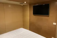 Modern bedroom interior on 2011 Custom C.boat 27 SC yacht, featuring a wall-mounted TV.