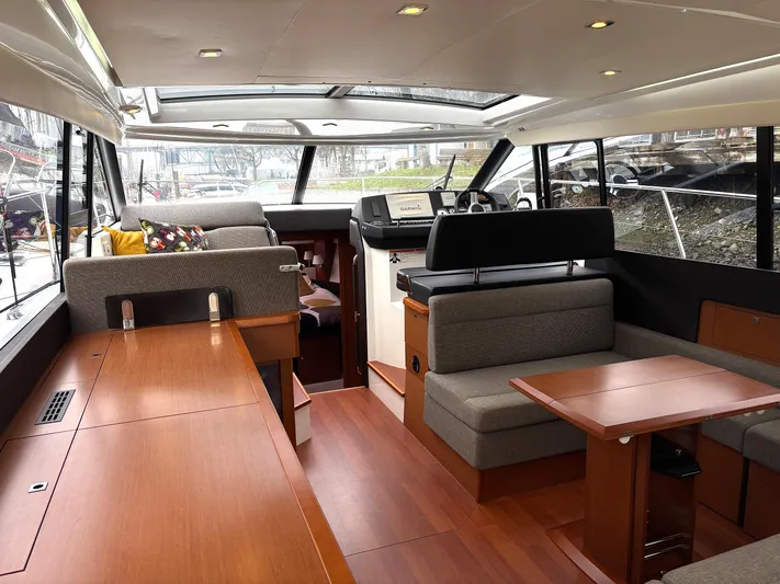  Yacht Photos Pics Interior of 2014 Jeanneau NC 14 yacht with modern seating and wooden finishes.