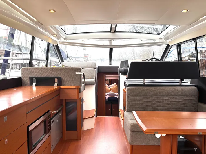  Yacht Photos Pics Interior of 2014 Jeanneau NC 14 yacht with modern kitchen and seating area.