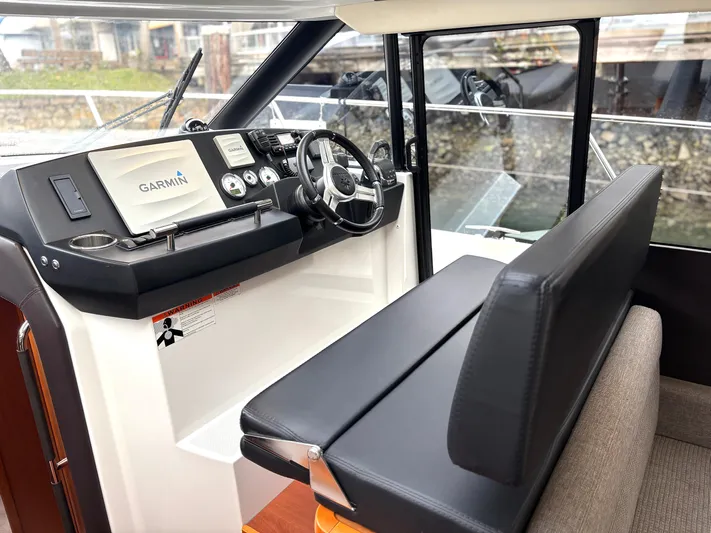  Yacht Photos Pics 2014 Jeanneau NC 14 helm with Garmin navigation system and sleek seating.