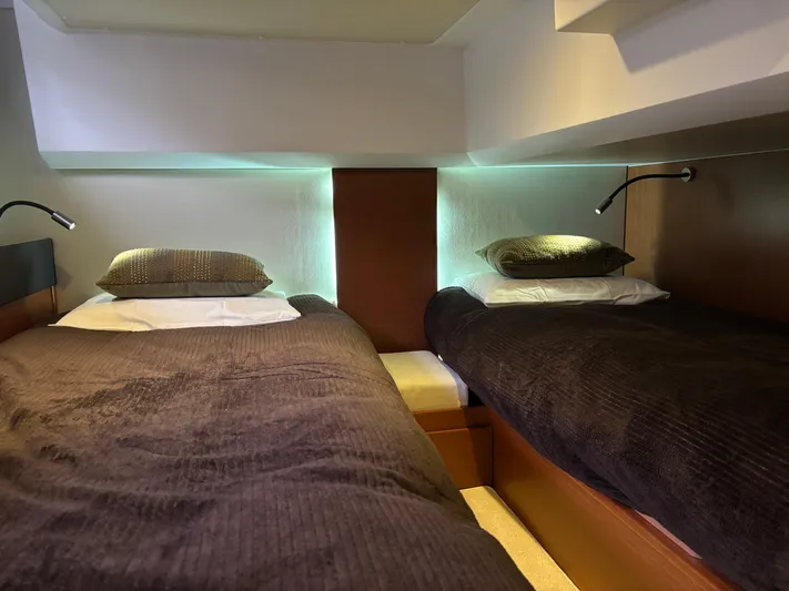  Yacht Photos Pics Twin beds in the cozy cabin of a 2014 Jeanneau NC 14 yacht.