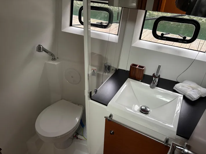  Yacht Photos Pics Bathroom interior of 2014 Jeanneau NC 14 yacht with sink and toilet.