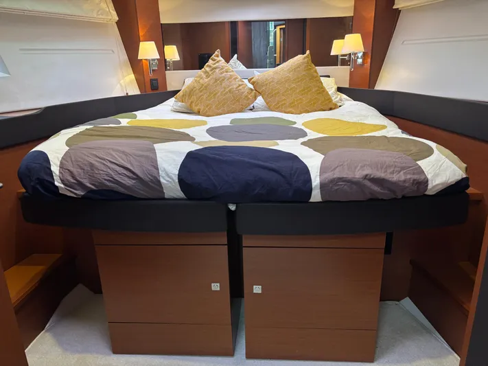  Yacht Photos Pics Luxurious bedroom interior of 2014 Jeanneau NC 14 yacht with modern bedding and lighting.