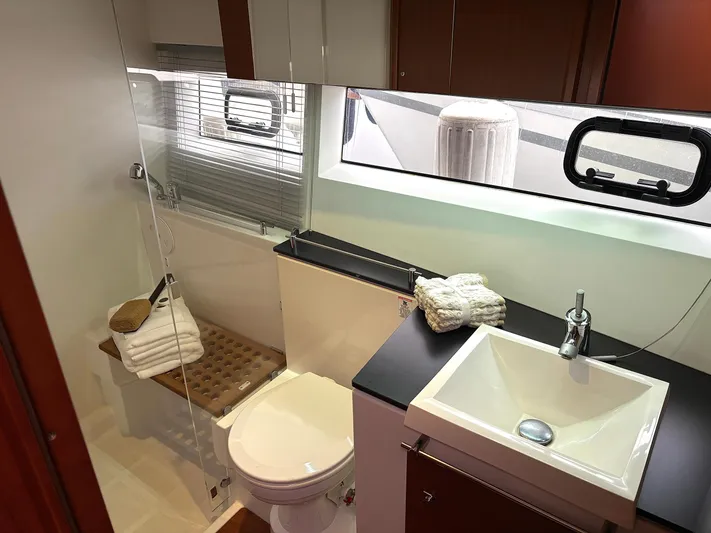  Yacht Photos Pics Luxurious bathroom in 2014 Jeanneau NC 14 yacht with modern fixtures and natural light.