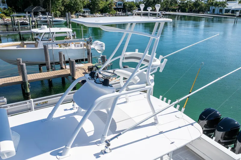  Yacht Photos Pics 2015 Intrepid 400 Center Console boat docked, featuring fishing rods and a clear blue water backdrop.