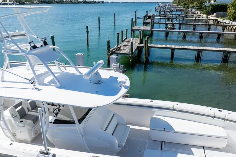  Yacht Photos Pics 2015 Intrepid 400 Center Console boat docked by a serene waterfront.