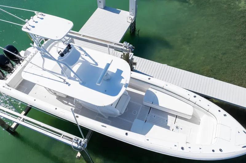 Yacht Photos Pics 2015 Intrepid 400 Center Console boat docked on clear green water.