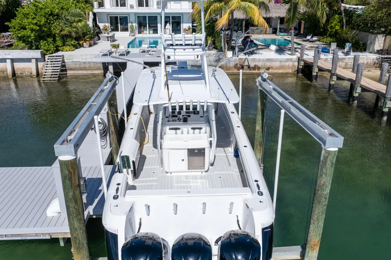  Yacht Photos Pics 2015 Intrepid 400 Center Console boat docked near waterfront home.