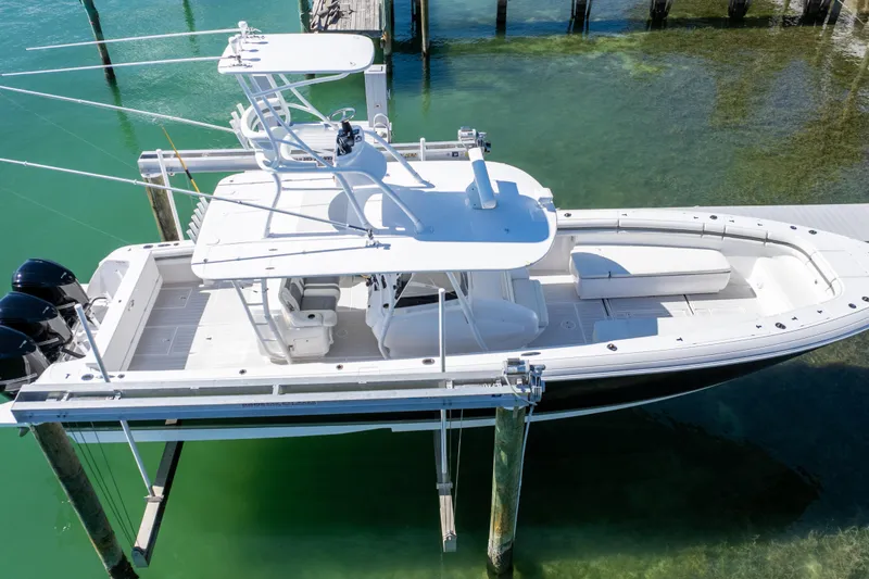  Yacht Photos Pics 2015 Intrepid 400 Center Console boat on lift over clear water.