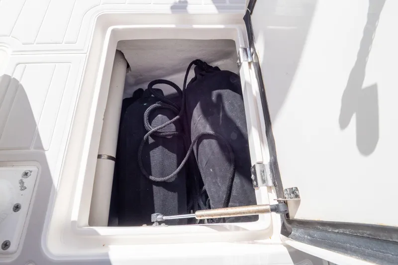  Yacht Photos Pics Storage compartment on 2015 Intrepid 400 Center Console boat, containing black bags.