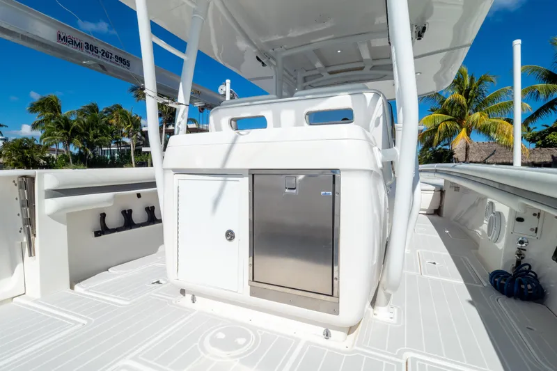  Yacht Photos Pics 2015 Intrepid 400 Center Console boat deck with storage, set against a tropical backdrop.
