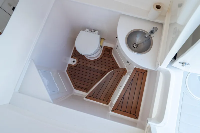  Yacht Photos Pics 2015 Intrepid 400 Center Console bathroom with wooden flooring and compact sink.