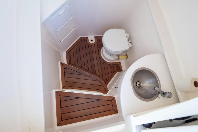  Yacht Photos Pics 2015 Intrepid 400 Center Console bathroom with wooden flooring and compact sink.