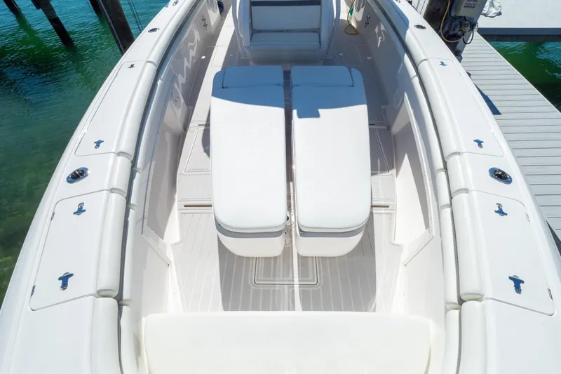  Yacht Photos Pics 2015 Intrepid 400 Center Console boat with white seating and deck, docked by clear water.