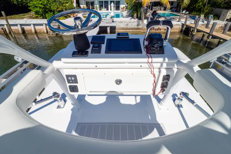  Yacht Photos Pics 2015 Intrepid 400 Center Console helm with steering wheel and navigation controls.