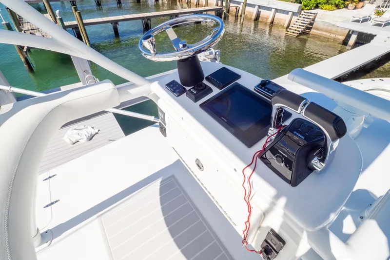  Yacht Photos Pics Control panel of a 2015 Intrepid 400 Center Console boat docked by the water.