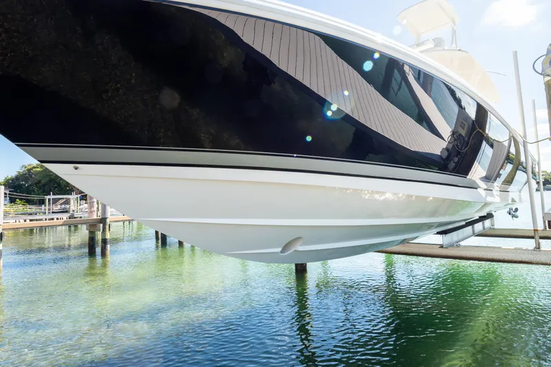  Yacht Photos Pics 2015 Intrepid 400 Center Console boat on lift over clear water.