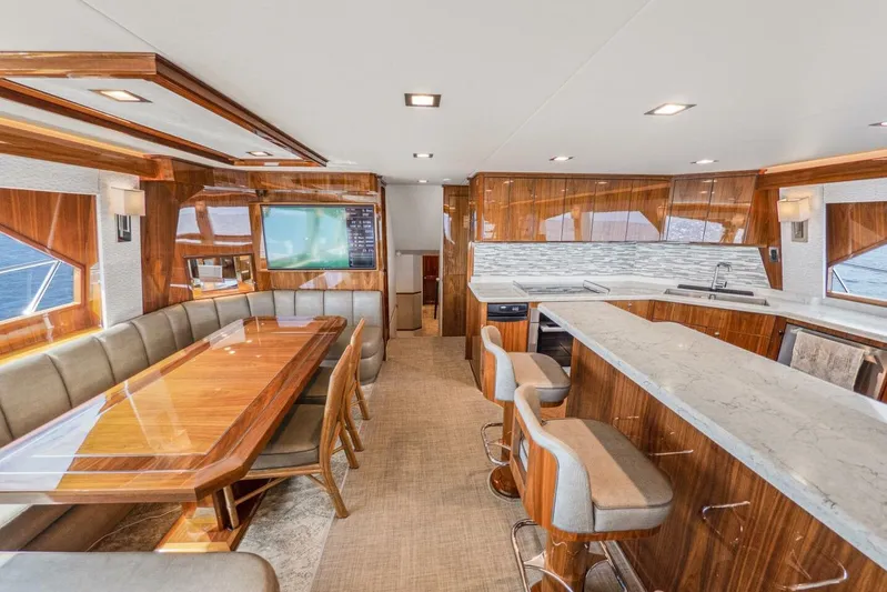 Marlin Magic Yacht Photos Pics Luxurious interior of 2021 Viking 92 Skybridge yacht with elegant dining and bar area.