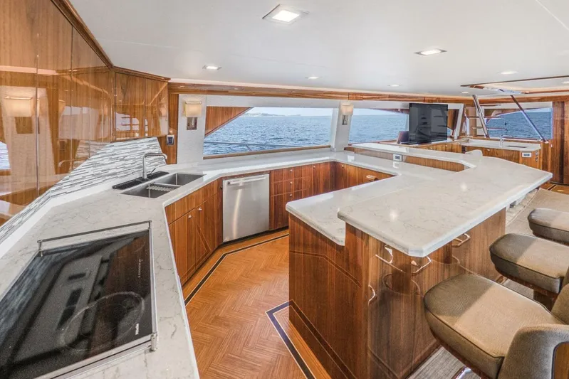 Marlin Magic Yacht Photos Pics Luxurious kitchen interior of 2021 Viking 92 Skybridge yacht with ocean view.